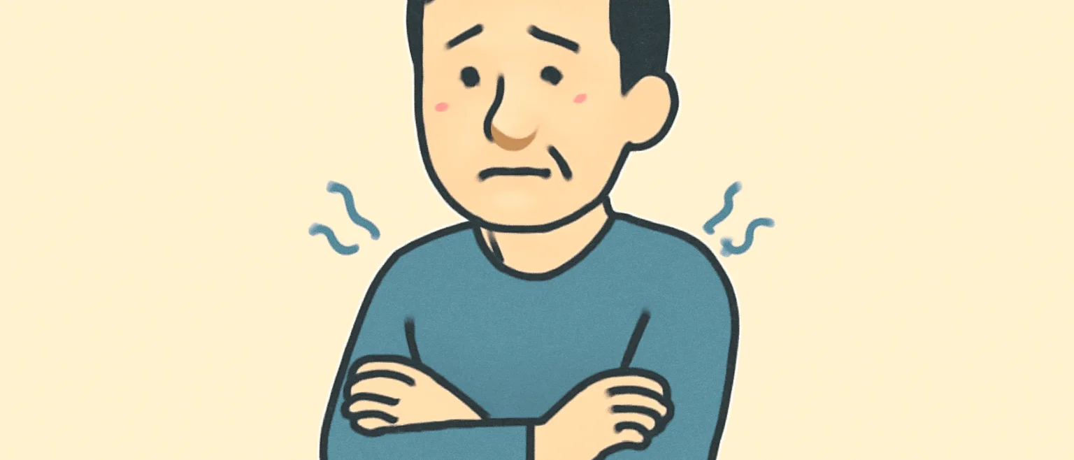 壁紙の断熱について、腕を組んで寒そうにしている男性のイラスト