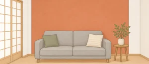 白い壁の洋室で、グレーのソファの後ろの1面だけがオレンジ系の壁紙になっているイラスト